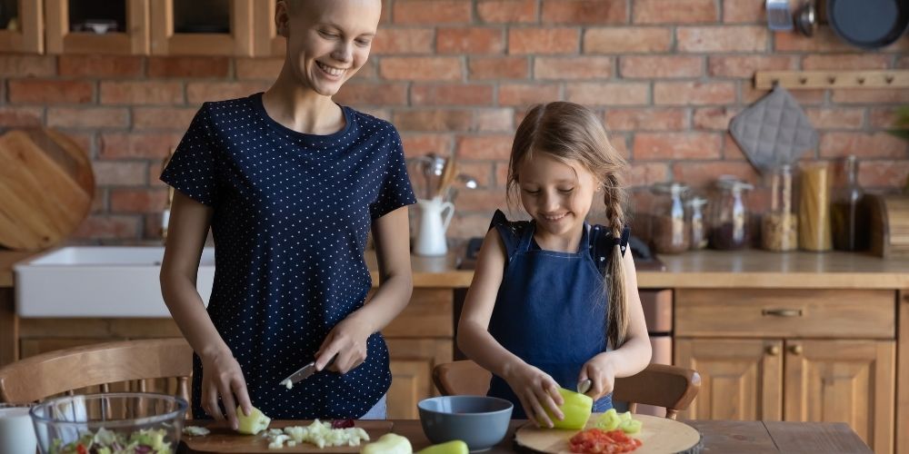 Happy Daughter Child Helping Cancer Patient Mom Cook Dinner