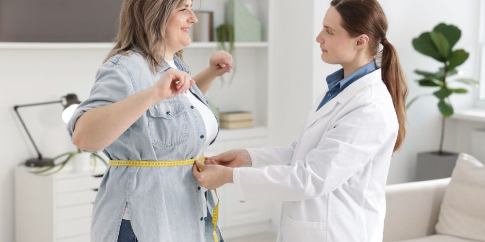 Nutritionist-Measuring-Happy-Woman-waist.jpg