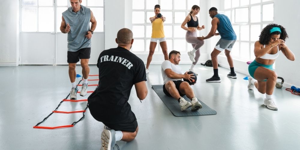 Trainer-guiding-athletes-performing-functional-training-exercise.jpg