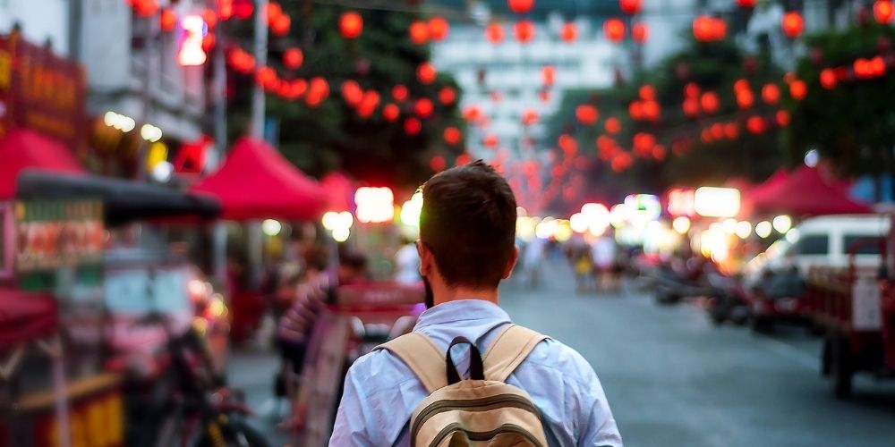 Traveler exploring Asian food market street