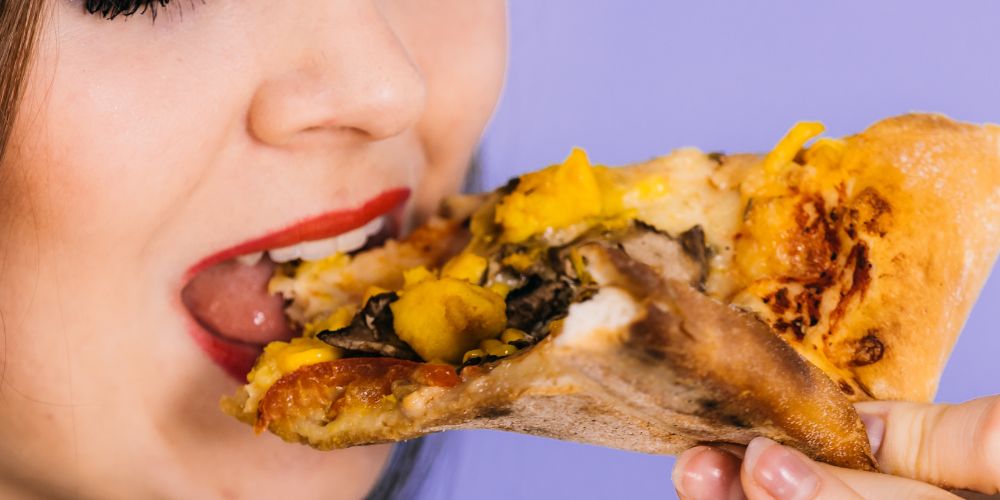 Woman-eating-hot-pizza-slice.jpg
