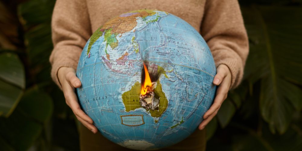 burning globe in hands